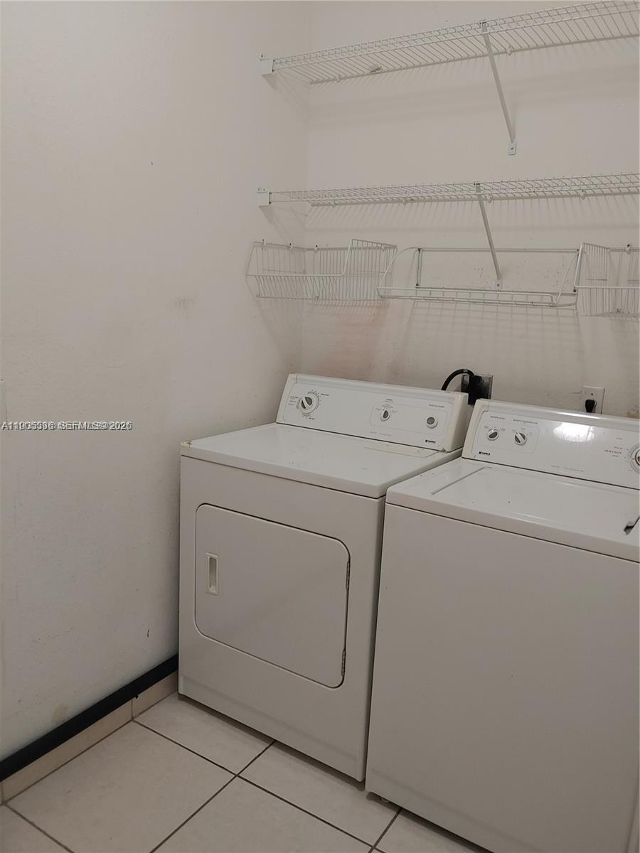7510 Northwest 175th Street, Unit 7510 Hialeah, FL 33015 - Photo 12 of 14 a utility room with dryer and washer