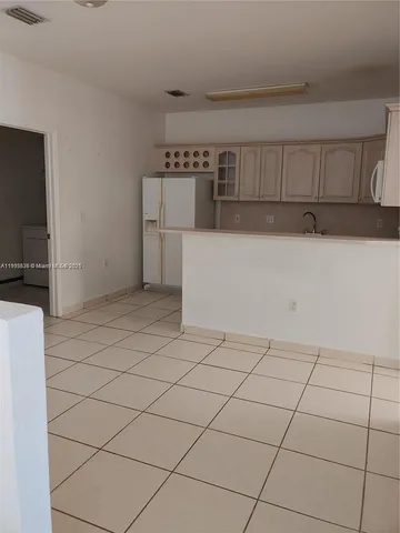 a kitchen with a cabinets and white appliances
