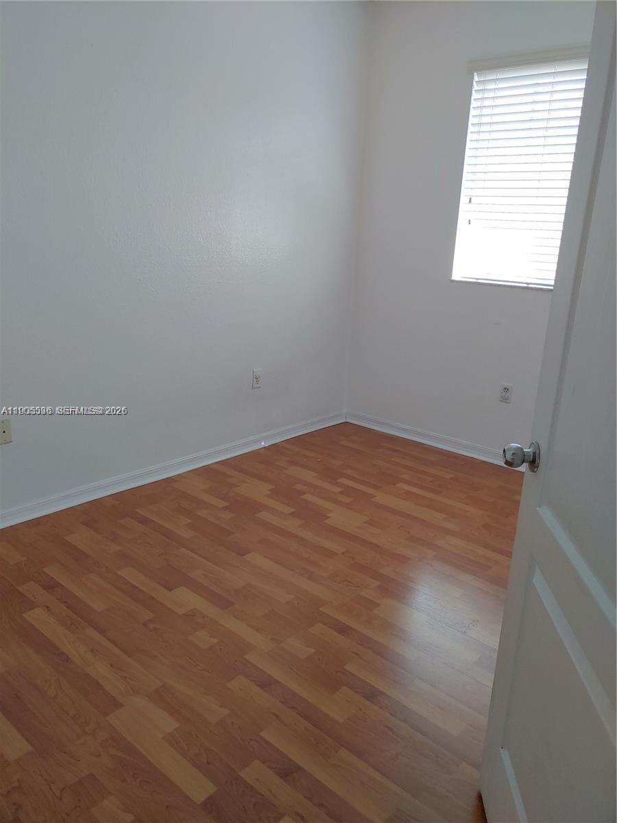 7510 Northwest 175th Street, Unit 7510 Hialeah, FL 33015 - Photo 6 of 14 an empty room with a window