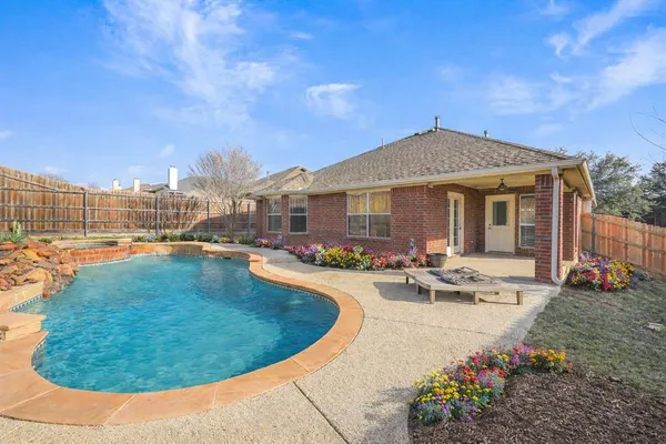 a view of a house with swimming pool and sitting area