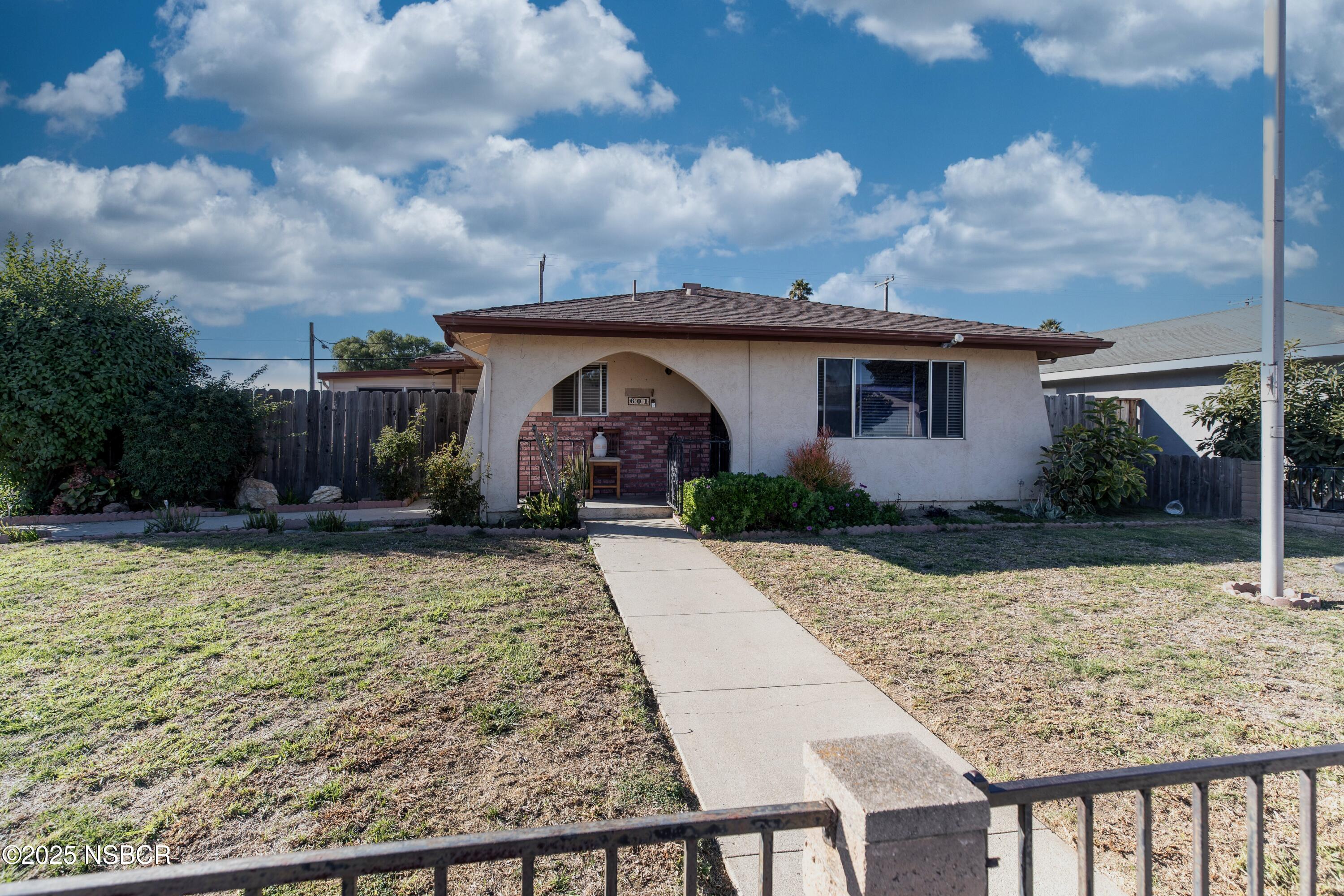 601 North Seventh Street Lompoc, CA 93436 - Photo 1 of 32 a front view of house with yard and trees around