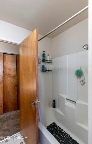 a bed room with a bed and a mirror