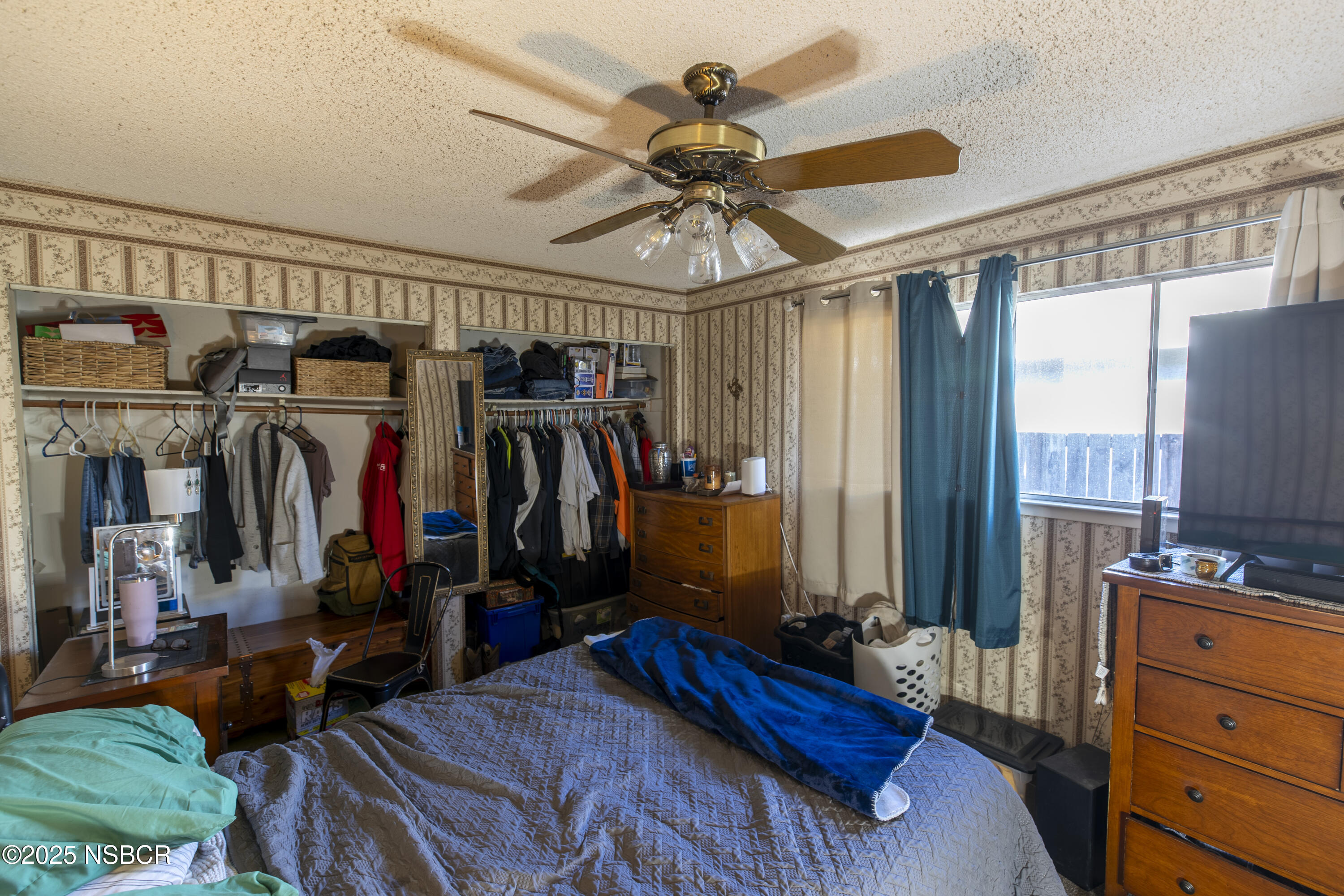 601 North Seventh Street Lompoc, CA 93436 - Photo 15 of 32 a bed room with a bed and a mirror