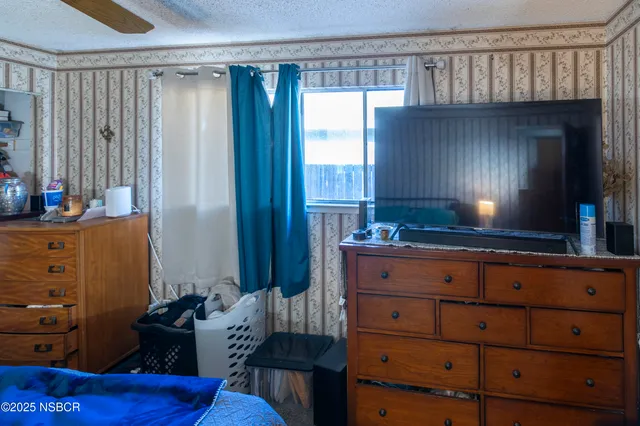 a view of a bedroom with furniture and clothes