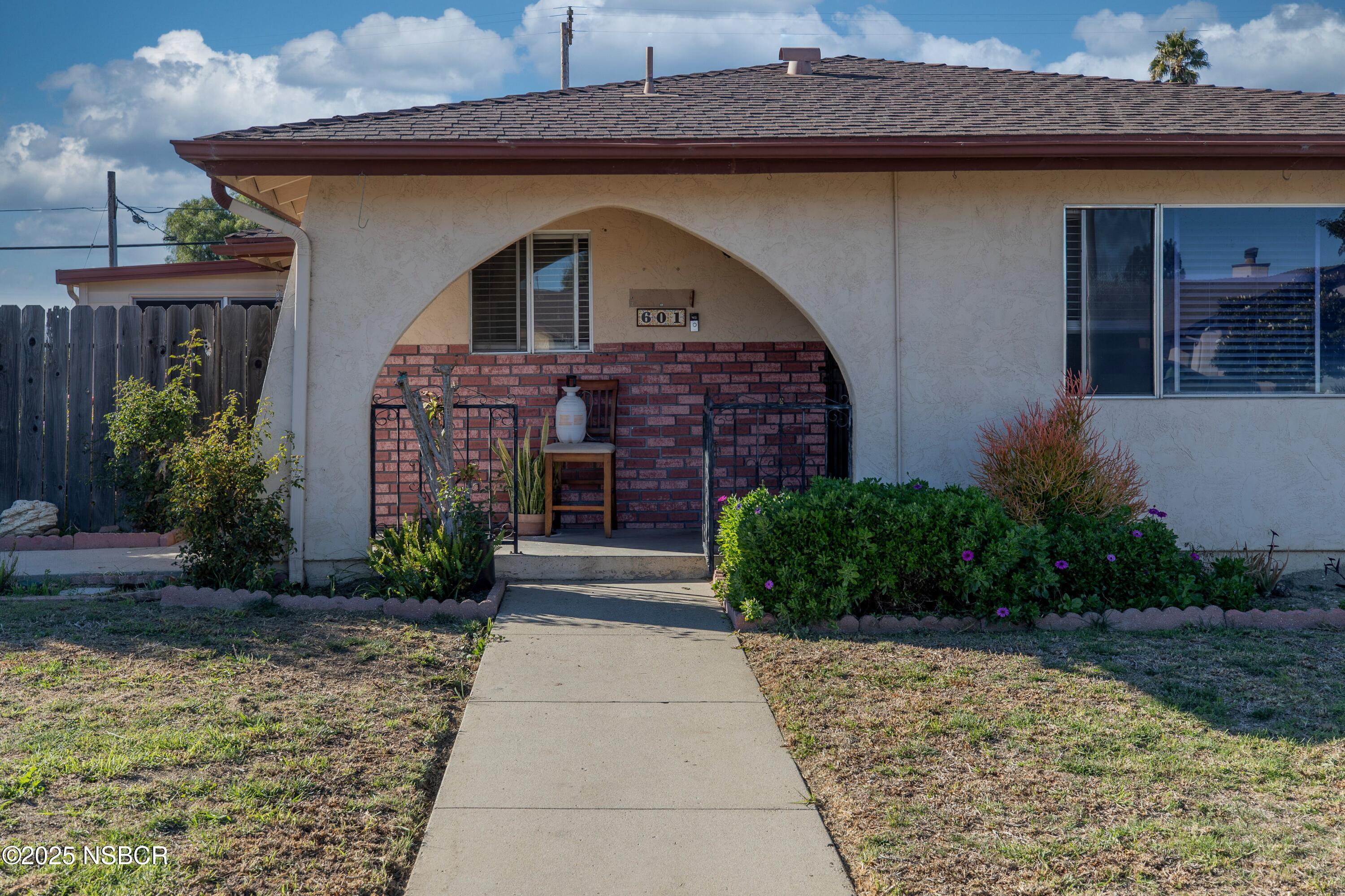 601 North Seventh Street Lompoc, CA 93436 - Photo 2 of 32 a front view of a house with garden