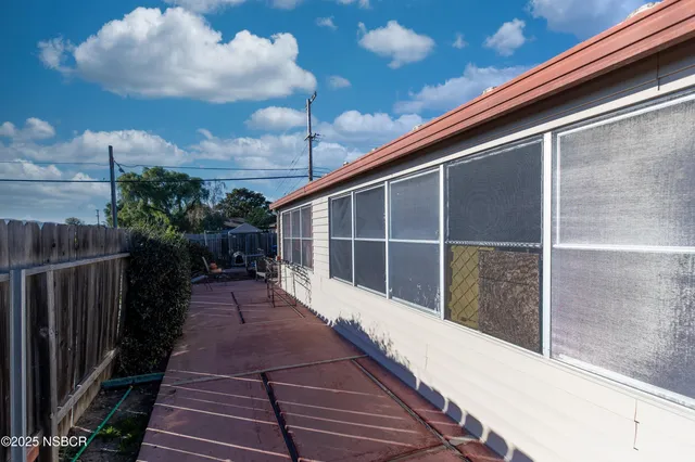 a view of backyard with wooden fence