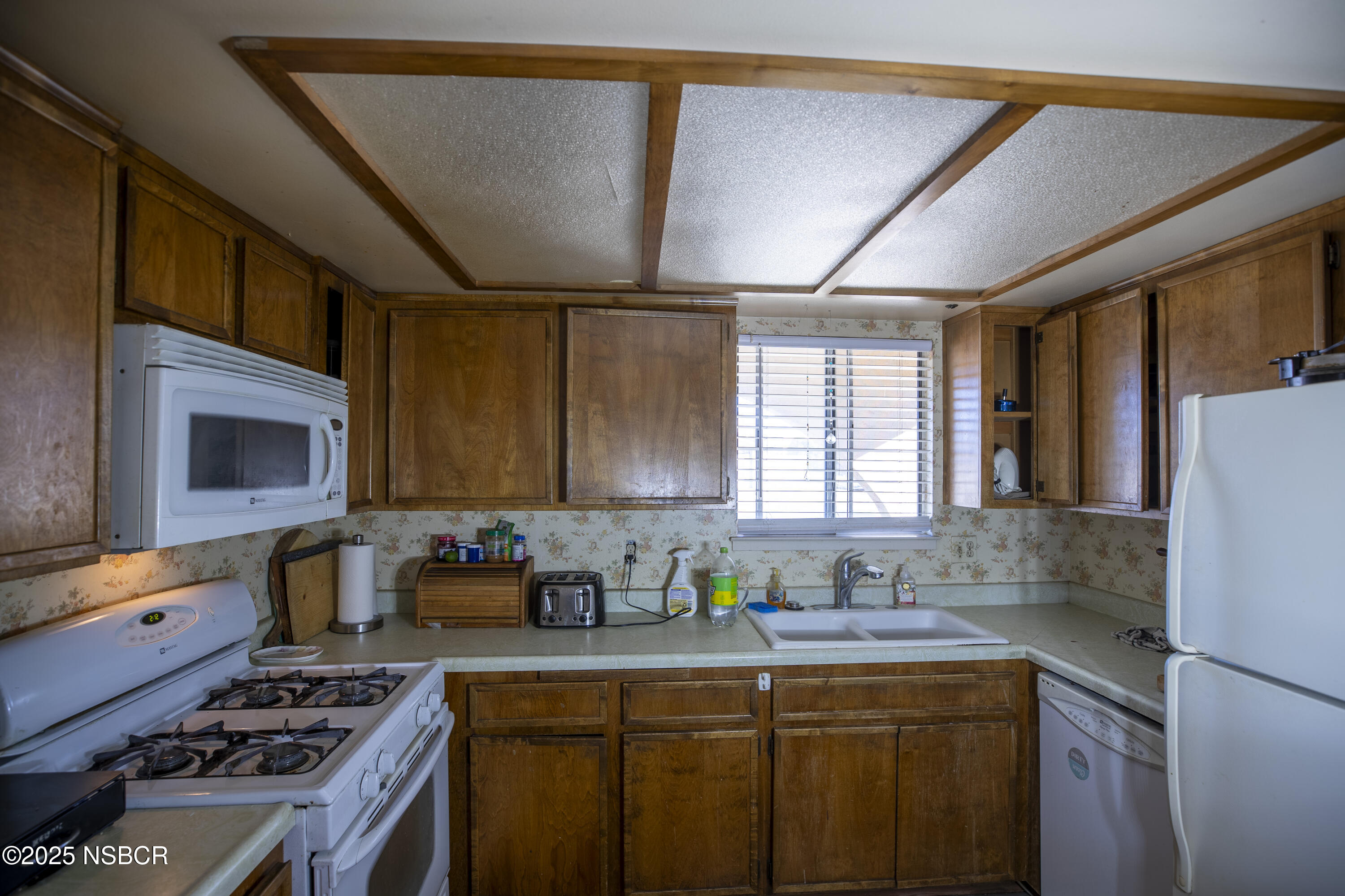 601 North Seventh Street Lompoc, CA 93436 - Photo 5 of 32 a kitchen with stainless steel appliances a stove a sink cabinets and a refrigerator