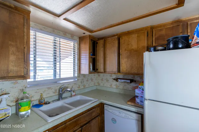a kitchen with a sink and a refrigerator