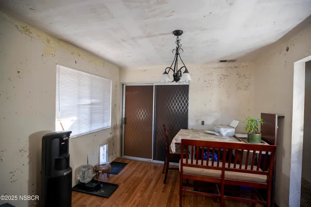 a bedroom with furniture and wooden floor