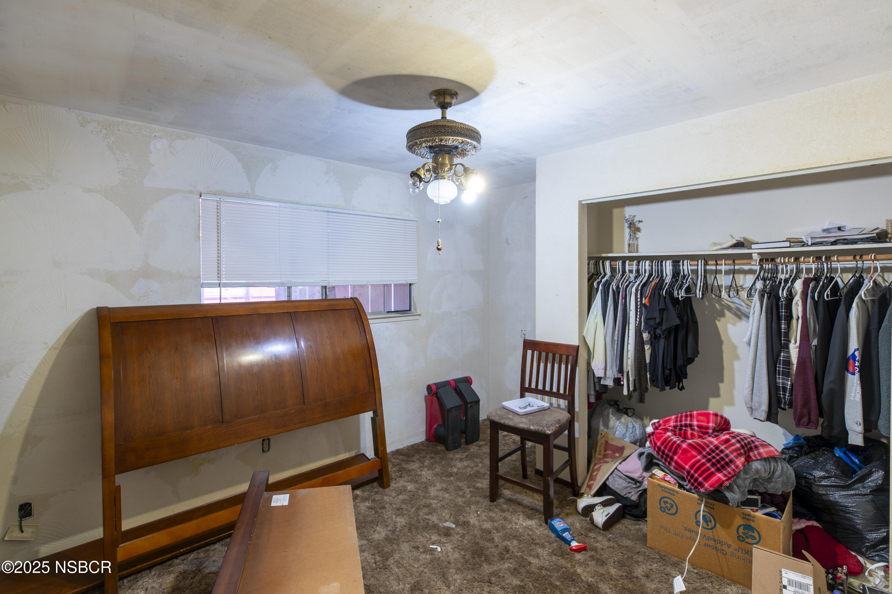 601 North Seventh Street Lompoc, CA 93436 - Photo 10 of 32 a room with a closet and a chandelier