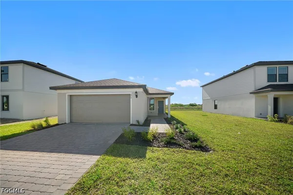 a front view of a house with a yard and garage