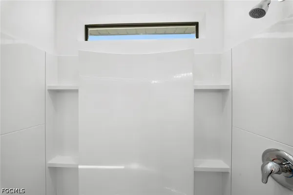 a bathroom with a sink a toilet a shower and a mirror