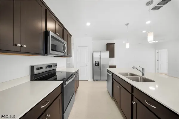 a kitchen with a sink stove and microwave