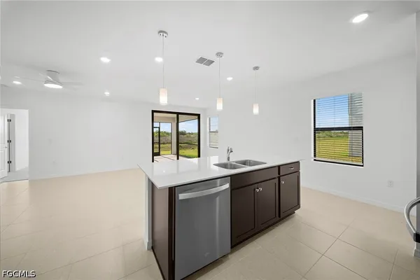 a kitchen with granite countertop a sink and cabinets