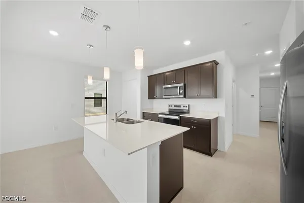 a kitchen with refrigerator and microwave
