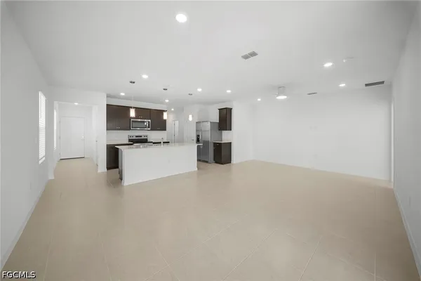 a view of an empty room with a stove top oven