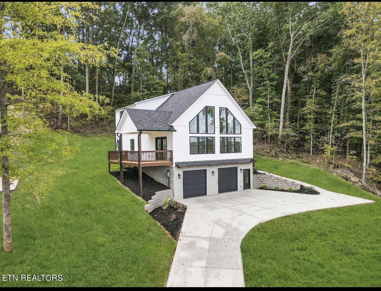 a view of a house with a yard and sitting area