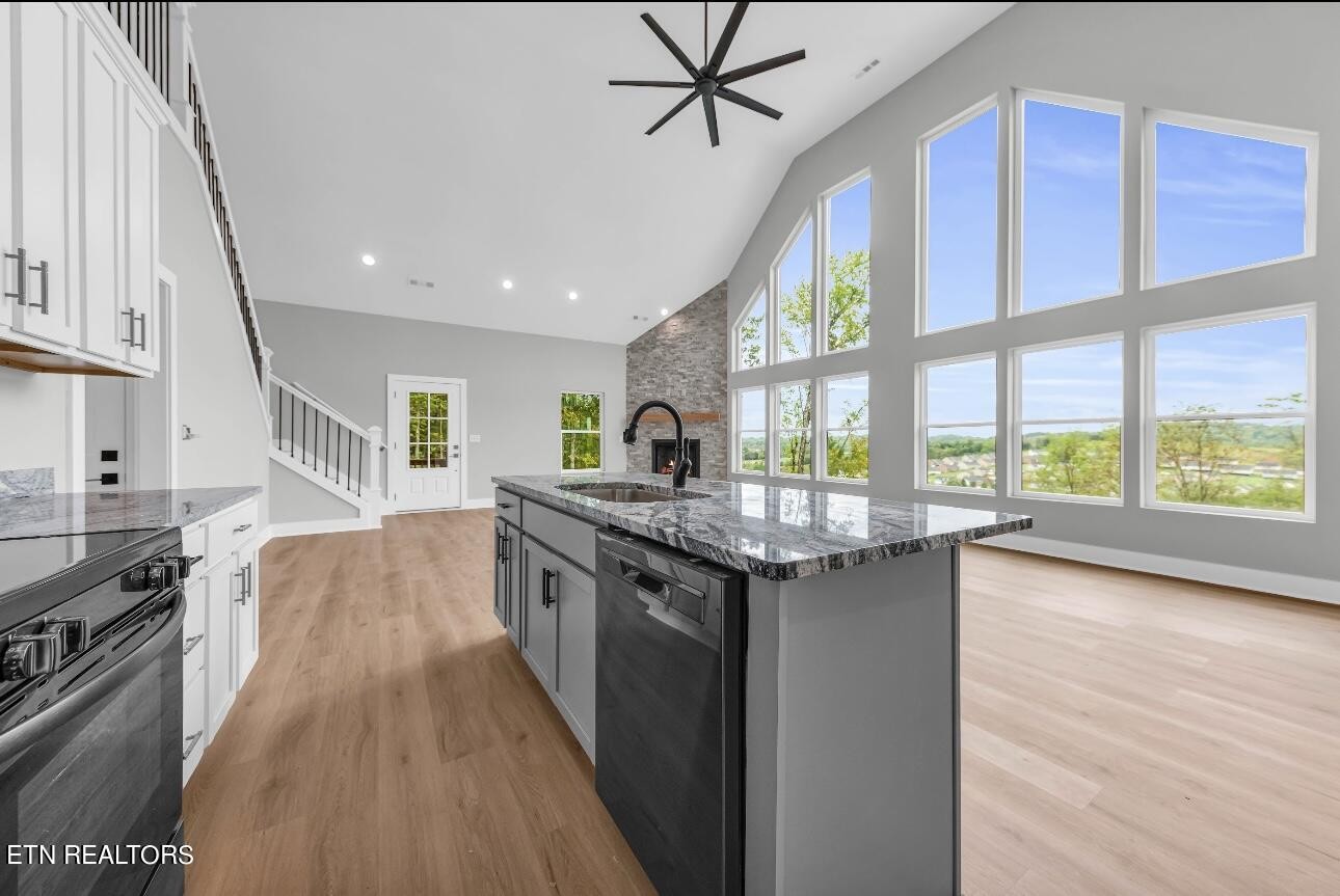246 Clear Creek Road Kodak, TN 37764 - Photo 13 of 23 a kitchen with stainless steel appliances granite countertop a stove and a wooden floors