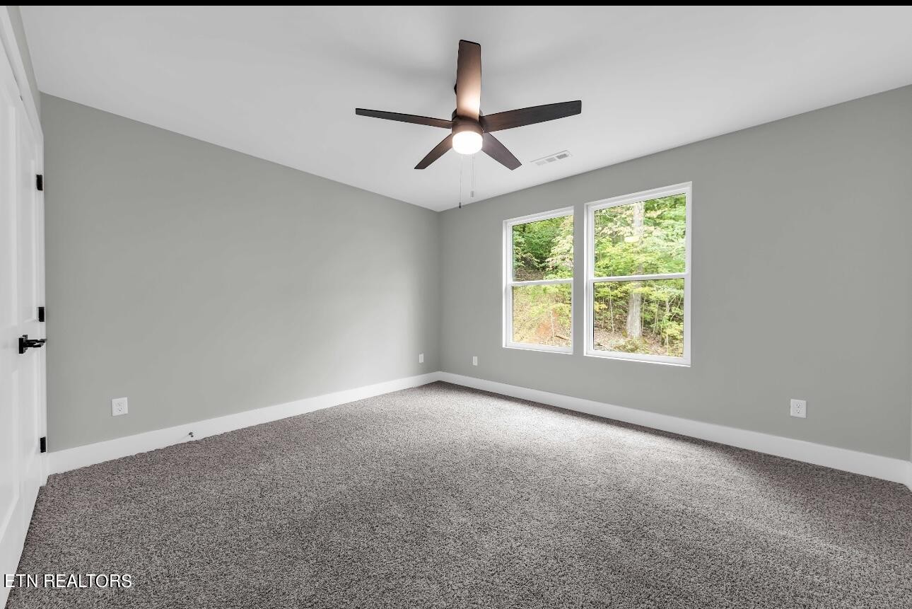 246 Clear Creek Road Kodak, TN 37764 - Photo 23 of 23 an empty room with a ceiling fan and window