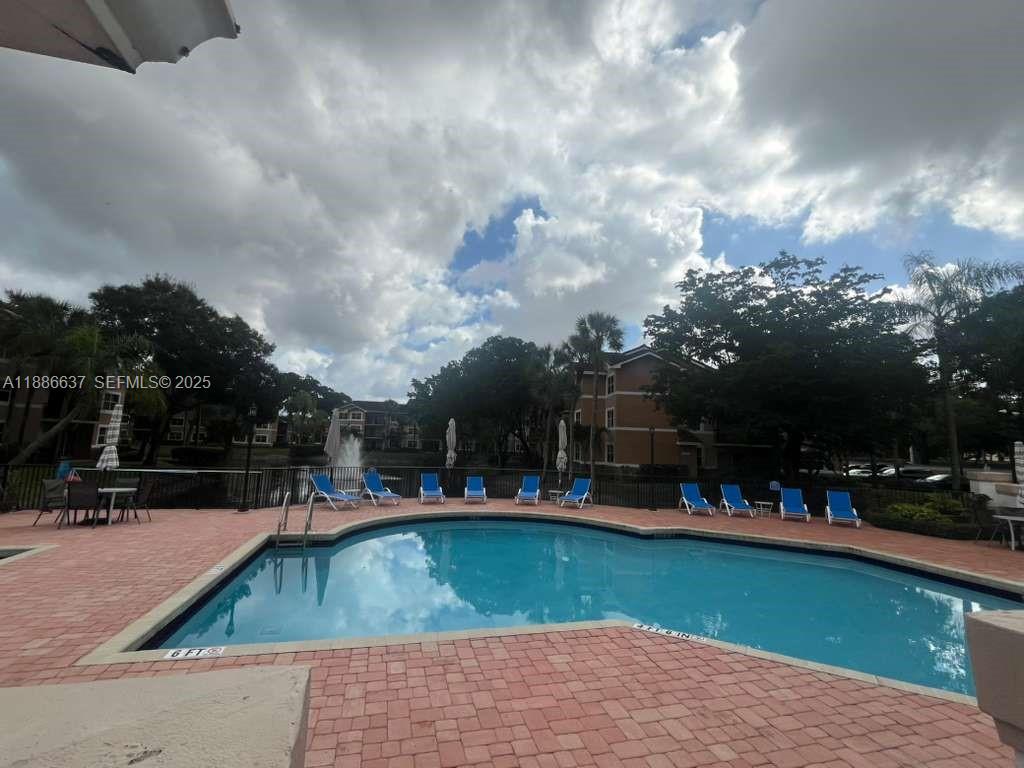 8801 Wiles Road, Unit 306 Coral Springs, FL 33067 - Photo 13 of 20 a view of outdoor space and swimming pool