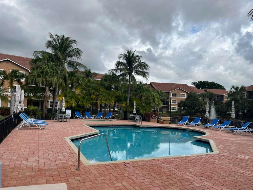 8801 Wiles Road, Unit 306 Coral Springs, FL 33067 - Photo 15 of 20 a view of outdoor space with swimming pool and lounge chair