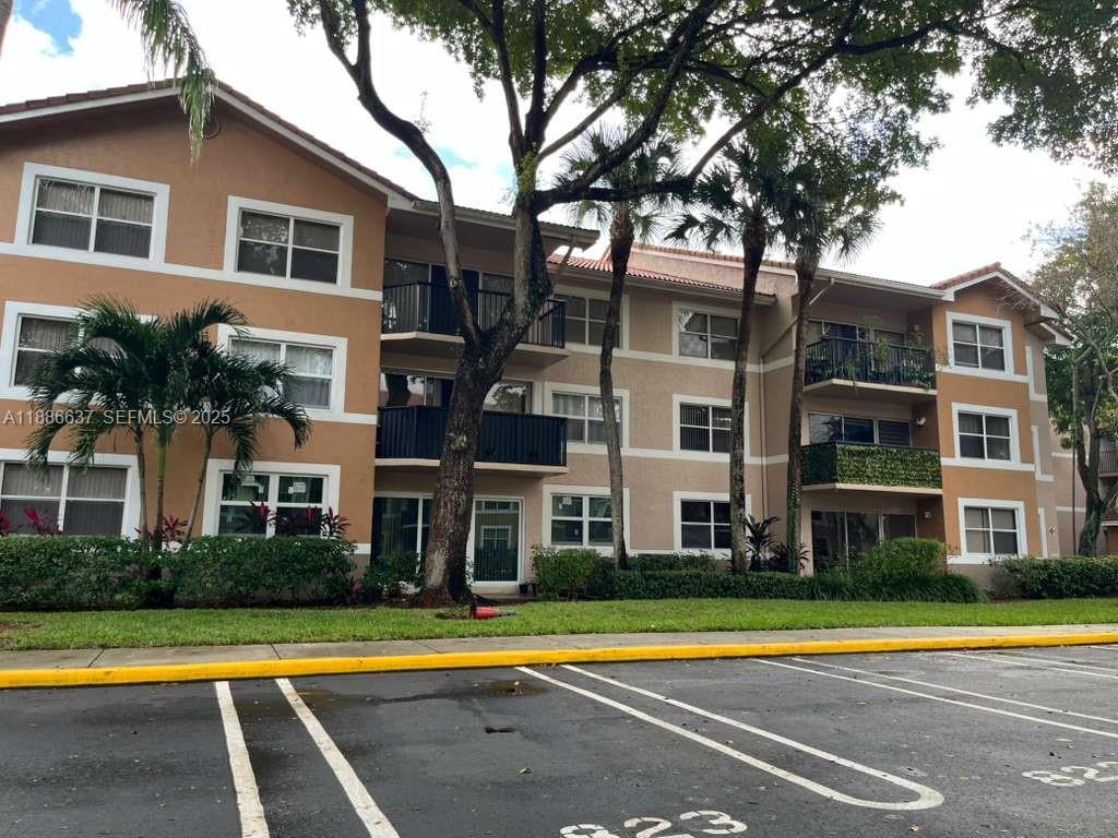 8801 Wiles Road, Unit 306 Coral Springs, FL 33067 - Photo 19 of 20 a view of a building with a swimming pool