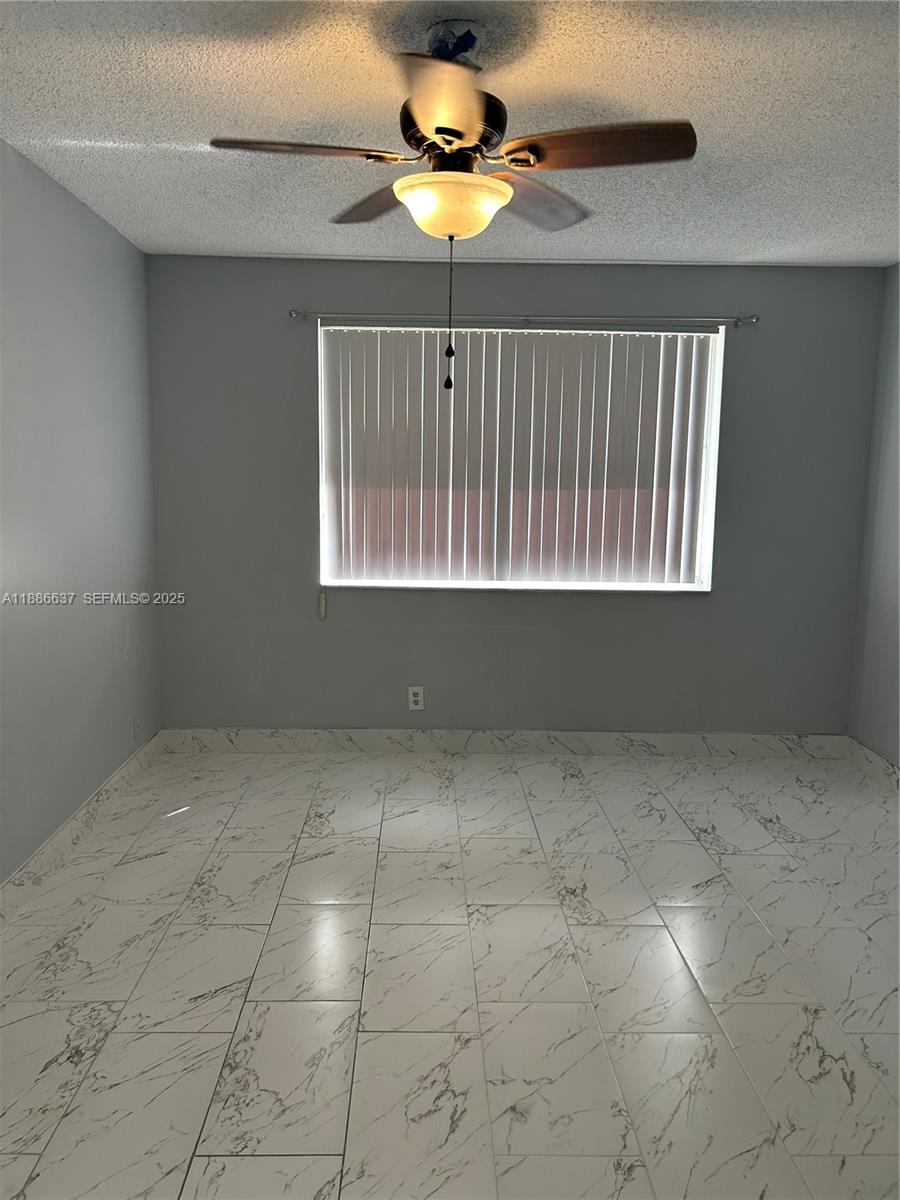 8801 Wiles Road, Unit 306 Coral Springs, FL 33067 - Photo 7 of 20 a view of an empty room with a window