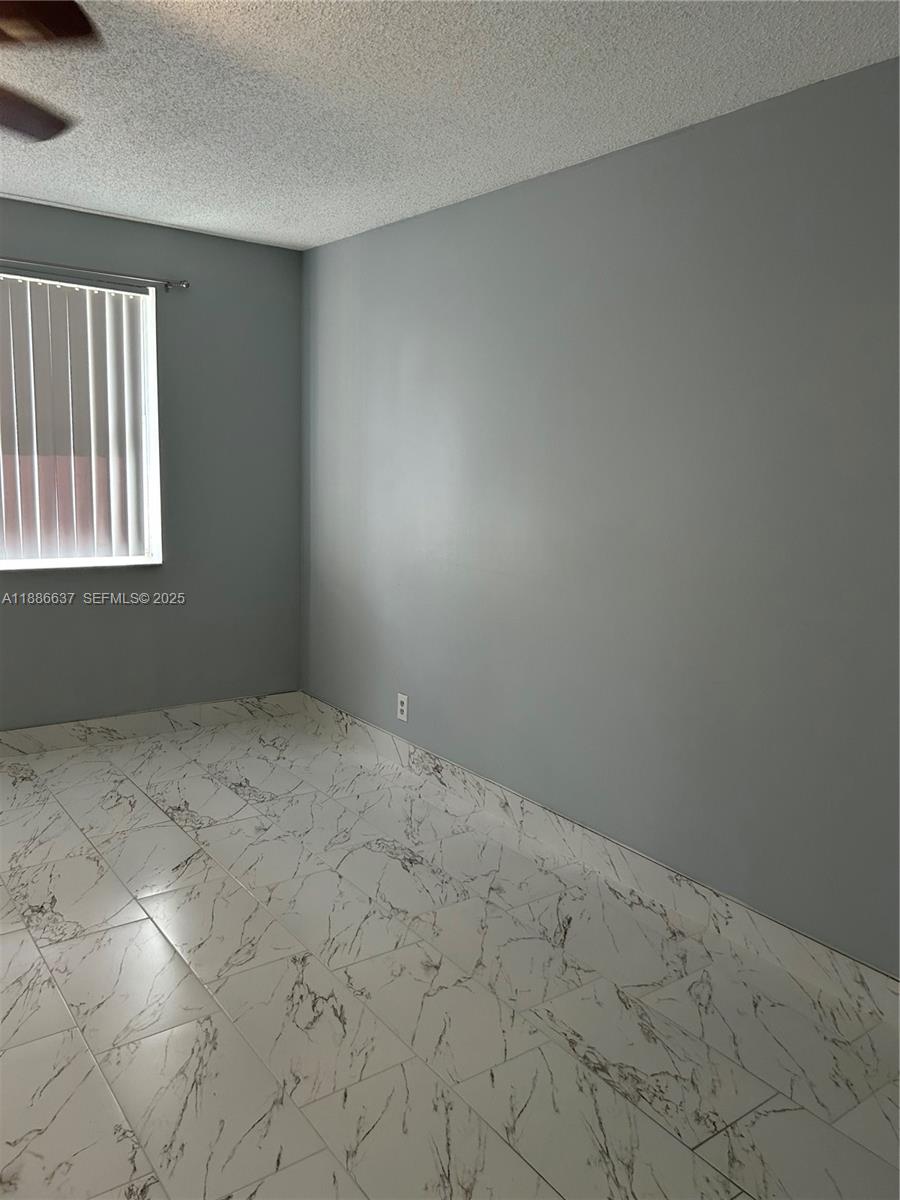 8801 Wiles Road, Unit 306 Coral Springs, FL 33067 - Photo 8 of 20 a view of an empty room and window