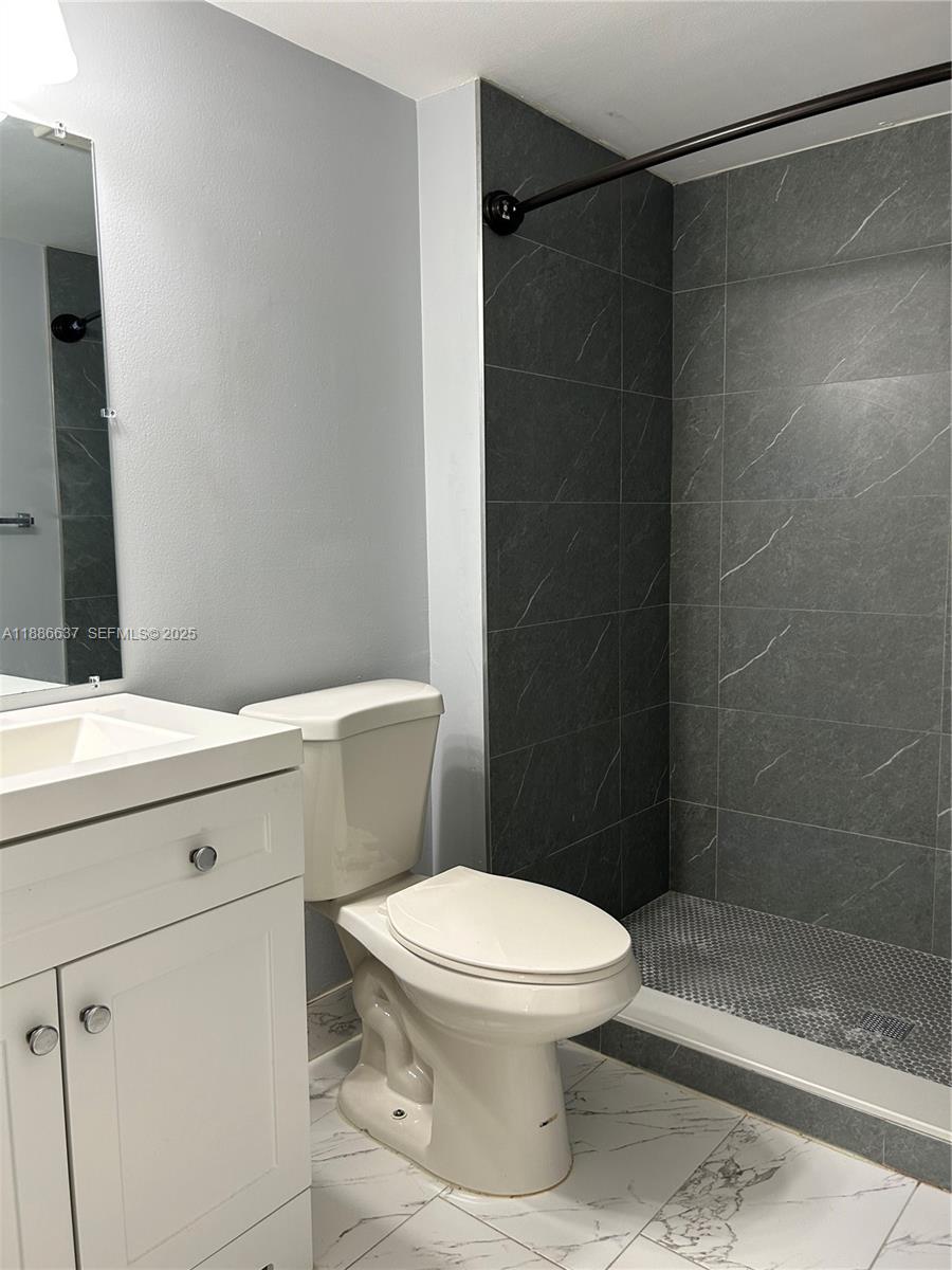 8801 Wiles Road, Unit 306 Coral Springs, FL 33067 - Photo 9 of 20 a white toilet and shower
