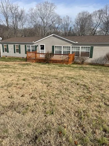 a view of a house with pool and trees