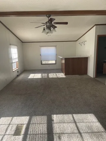 a view of a room with a ceiling fan