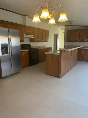 a kitchen with cabinets a sink and stainless steel appliances