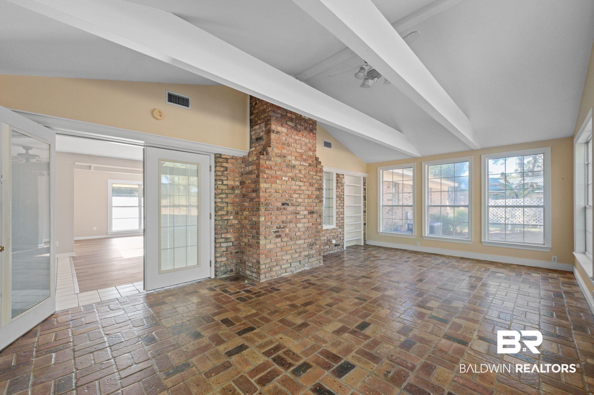 909 Caroline Avenue Daphne, AL 36526 - Photo 18 of 46 Unfurnished living room featuring ceiling fan, french doors, and lofted ceiling with beams