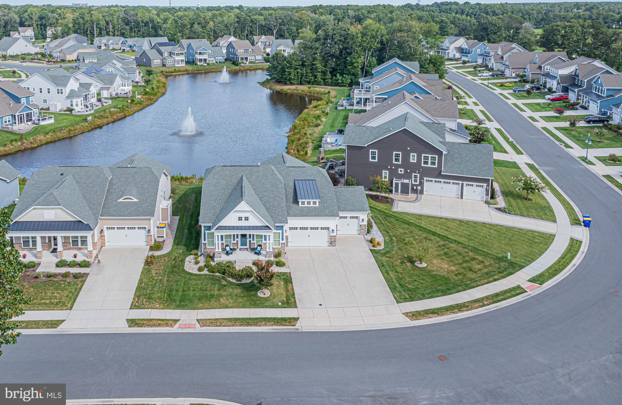 an aerial view of a house with a garden and lake view