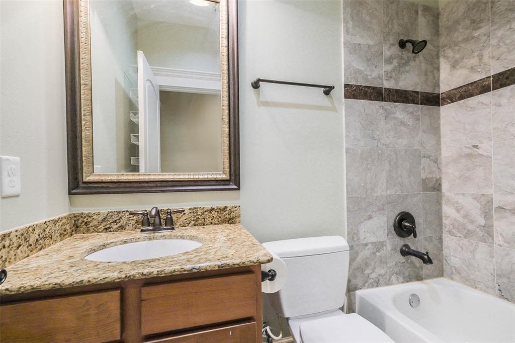 706 Allston Street, Unit B Houston, TX 77007 - Photo 10 of 33 a bathroom with a granite countertop sink toilet and shower