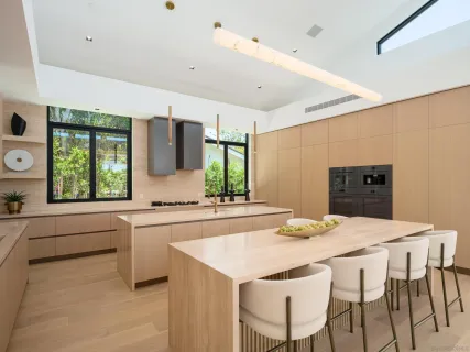 a kitchen with granite countertop a sink and white appliances