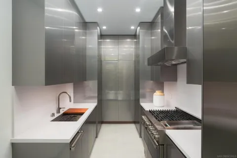 a kitchen with stainless steel appliances granite countertop a sink and a stove top oven