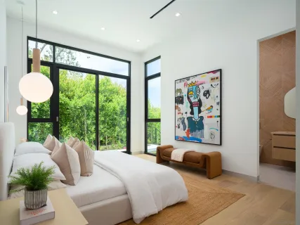 a bedroom with a bed and glass window