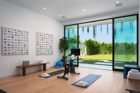 a living room with patio furniture and a potted plants