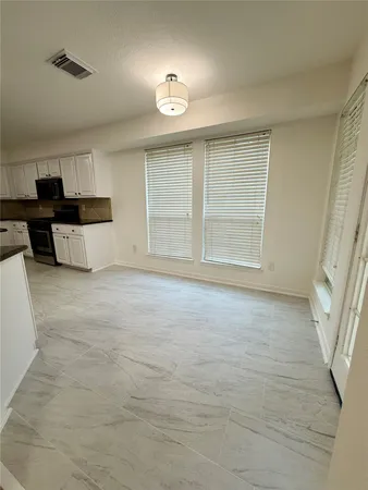 a view of kitchen with cabinets and wooden floor