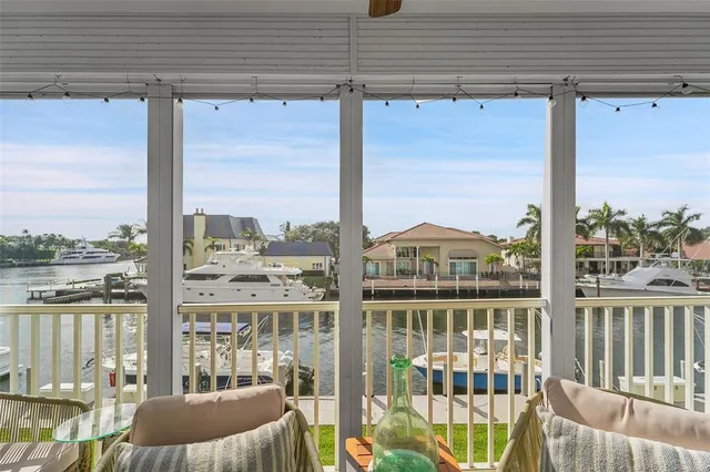 a view of a balcony with lake view and wooden floor