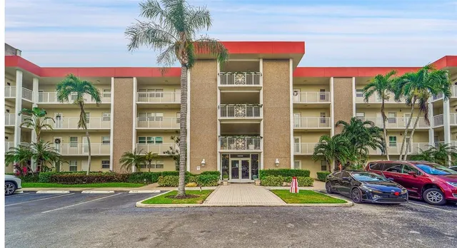 a view of a hallway with couches and dining table