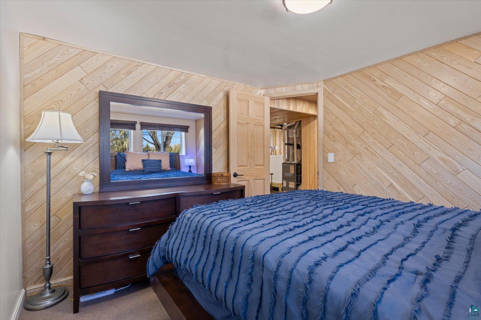 3495 Deer Forest Road Makinen, MN 55763 - Photo 14 of 71 Bedroom with wooden walls and dark colored carpet