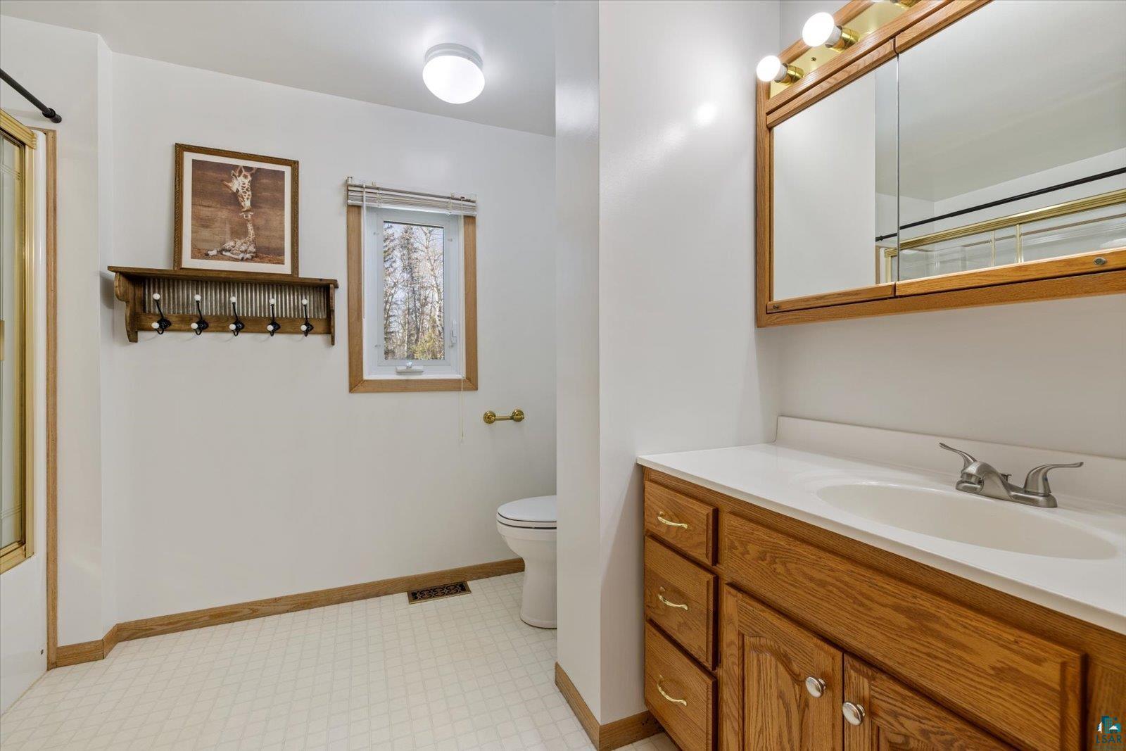 3495 Deer Forest Road Makinen, MN 55763 - Photo 28 of 71 Full bathroom with vanity, a shower with door, and light floors