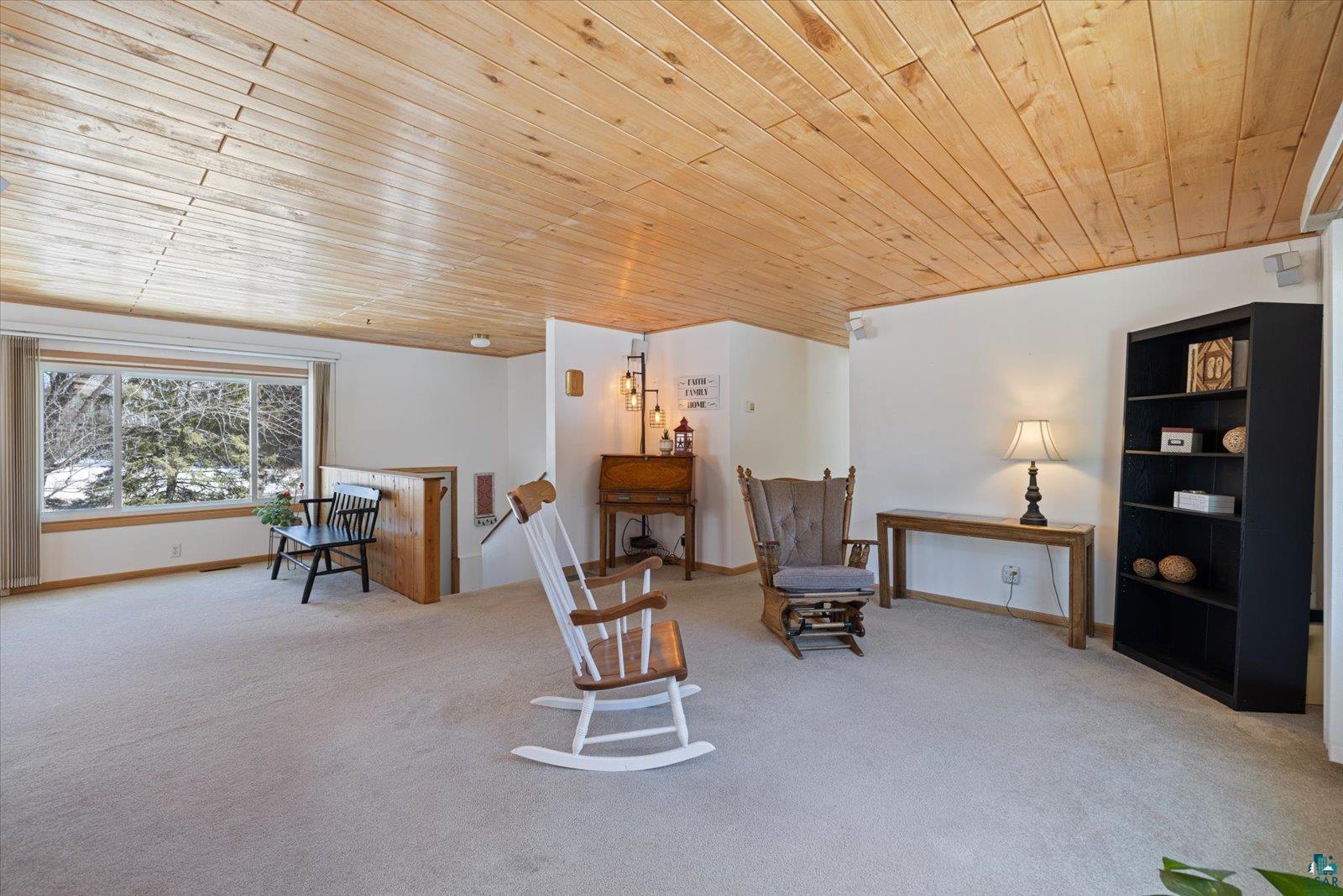 3495 Deer Forest Road Makinen, MN 55763 - Photo 35 of 71 Sitting room featuring wood ceiling, light carpet, and an upstairs landing