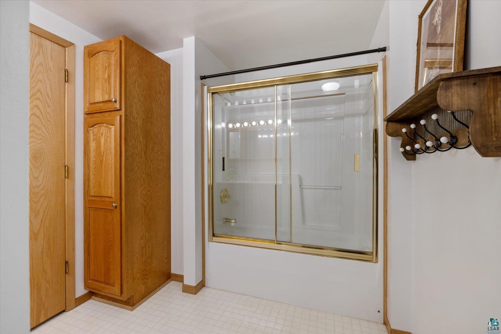 3495 Deer Forest Road Makinen, MN 55763 - Photo 39 of 71 Full bathroom featuring light flooring and bath / shower combo with glass door