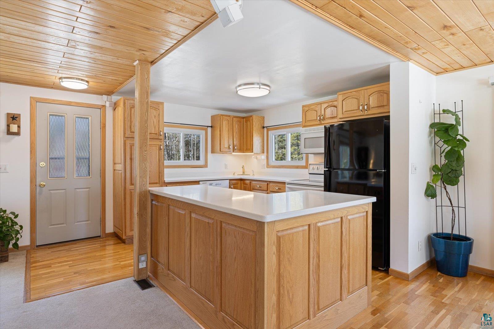 3495 Deer Forest Road Makinen, MN 55763 - Photo 5 of 71 Kitchen with wooden ceiling, white appliances, light countertops, light wood-style floors, and a center island