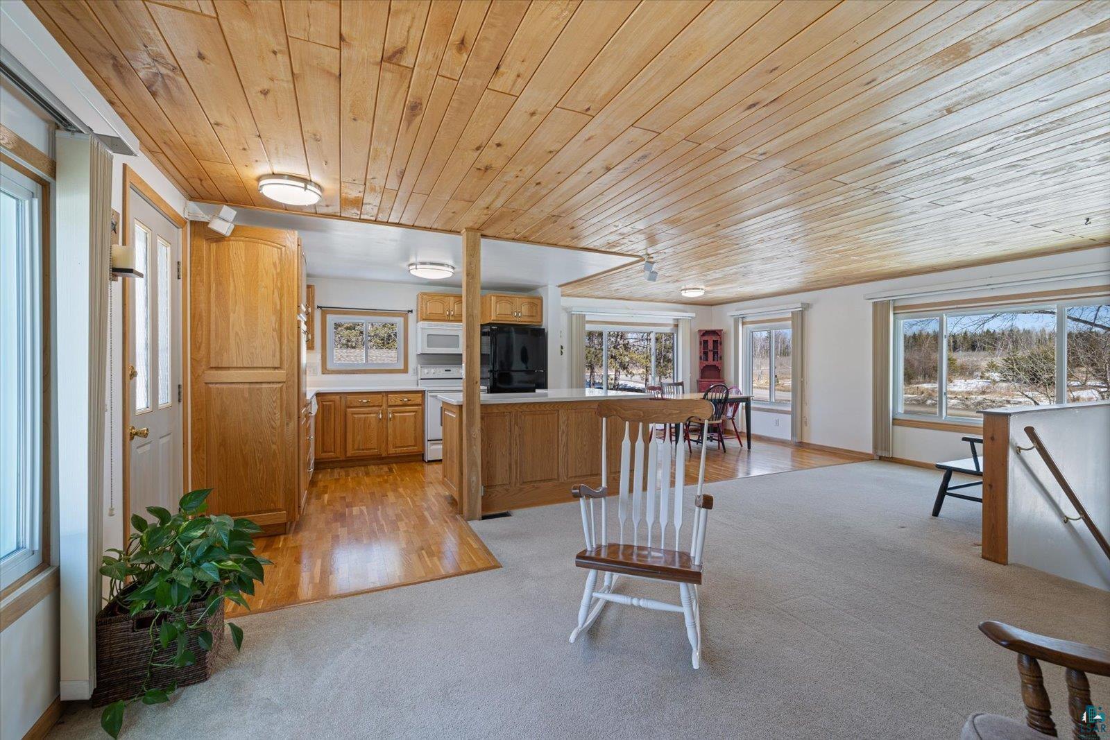3495 Deer Forest Road Makinen, MN 55763 - Photo 54 of 71 Kitchen featuring light countertops, wood ceiling, white appliances, light carpet, and wood finish cabinets
