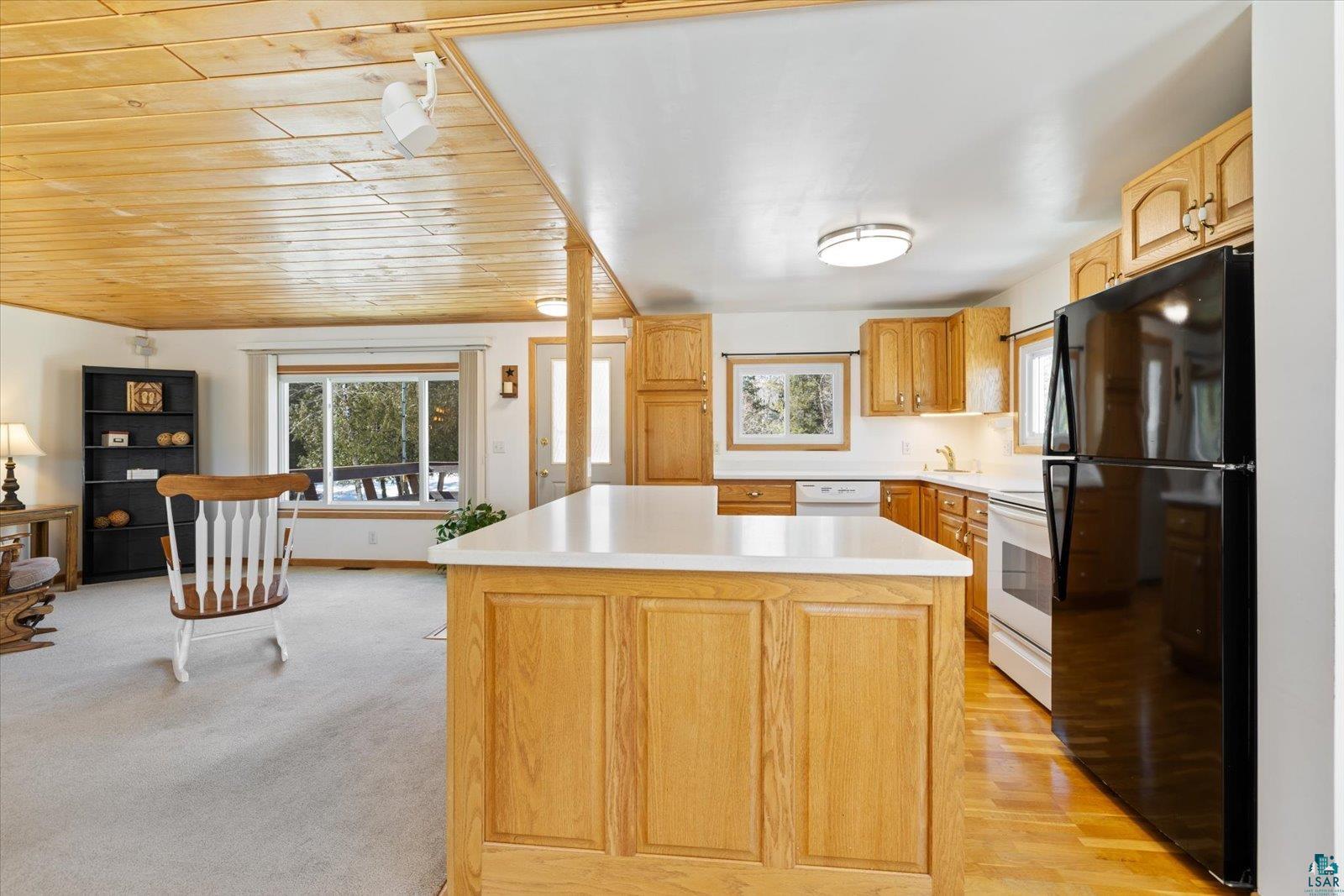 3495 Deer Forest Road Makinen, MN 55763 - Photo 57 of 71 Kitchen with white appliances, light countertops, a kitchen island, wooden ceiling, and light wood finish cabinetry