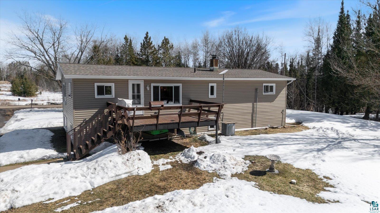 3495 Deer Forest Road Makinen, MN 55763 - Photo 69 of 71 Snow covered property featuring a chimney, a wooden deck, and a shingled roof